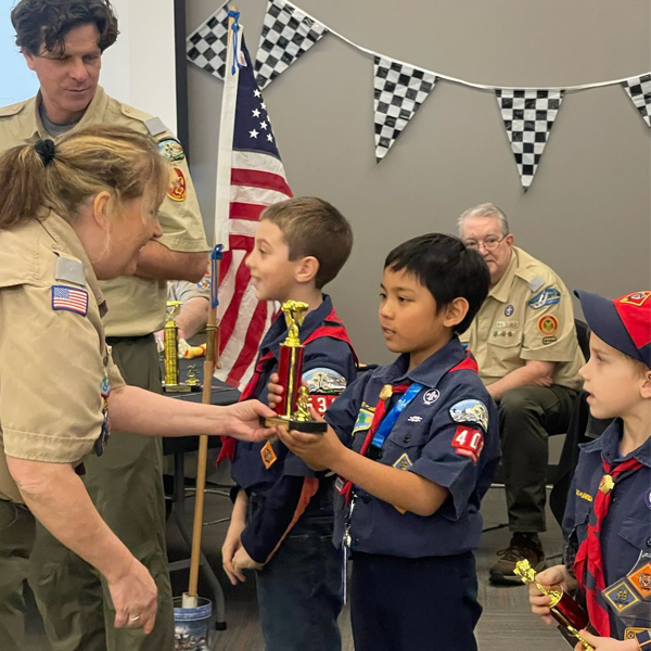 Wolf Cub Scouts receiving trophies at the Council Pinewood Derby