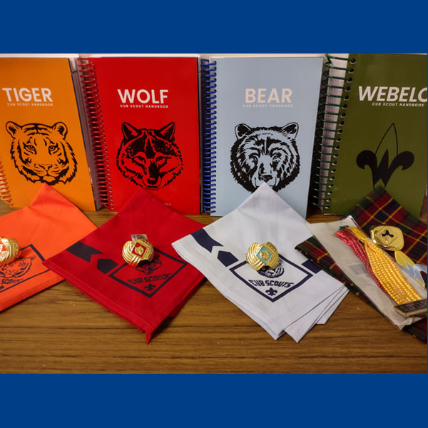 Cub Scout handbooks, neckerchiefs, and slides