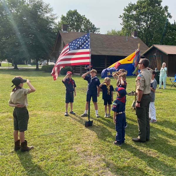 Cub Scouts saluting American flag