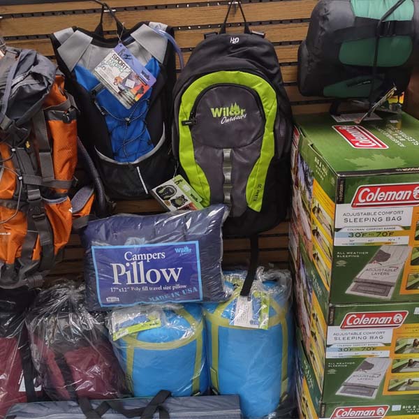 Camping gear, backpacks, sleeping bags, and pillows