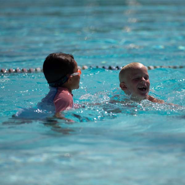 Two Cub Scouts swimming