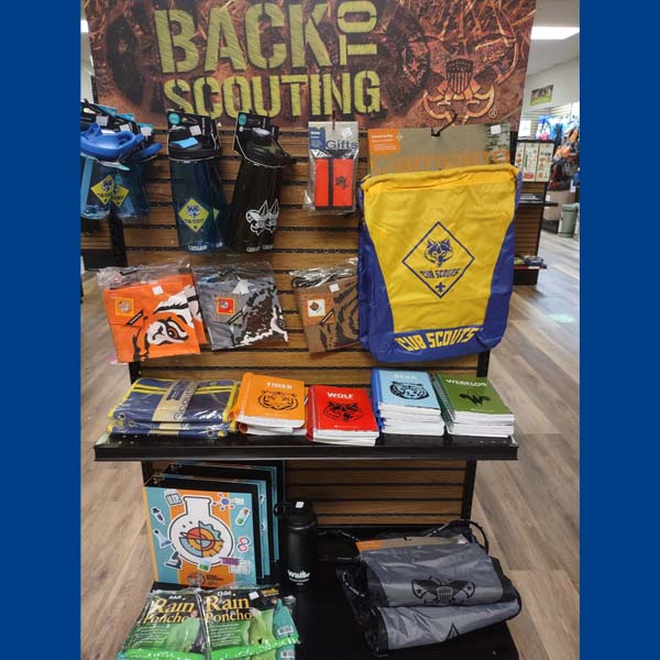 Photo of Scout Shop merchandise including books, bags, water bottles, ponchos, notebooks, and book covers