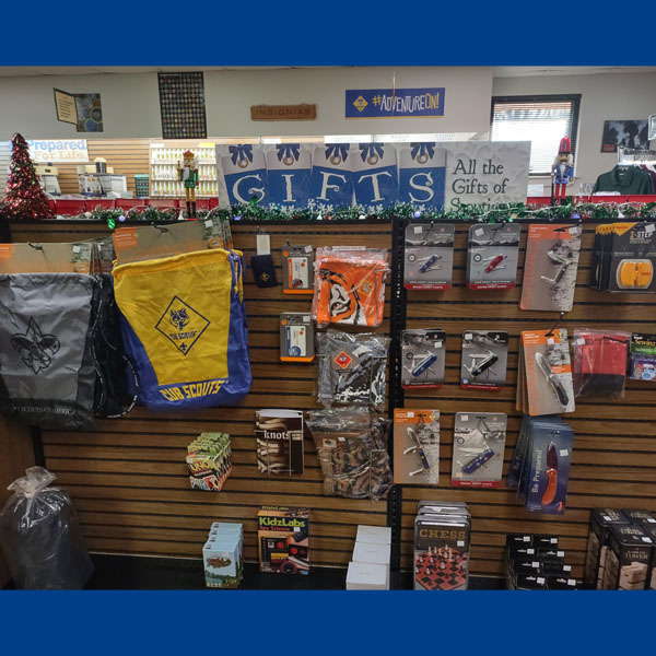 Photo of gifts available in the Scout Shop, including bags, games, and pocket knives.