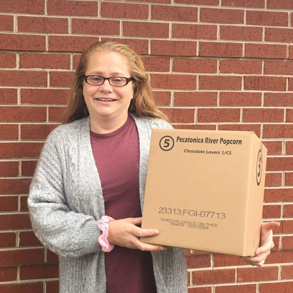 Photo of Beth Albertson holding a Chocolate Lovers popcorn box