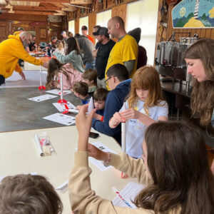 Scouts building rockets at Family Camp 2024 at Pipsico Scout Reservation