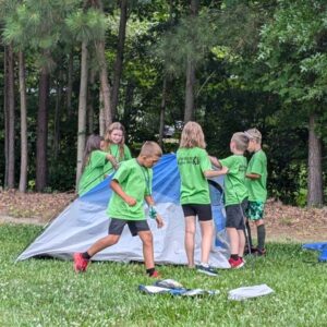 Cub Scouts at Elizabeth City Day Camp practicing putting up and taking down a tent