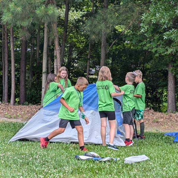Cub Scouts at Elizabeth City Day Camp practicing putting up and taking down a tent