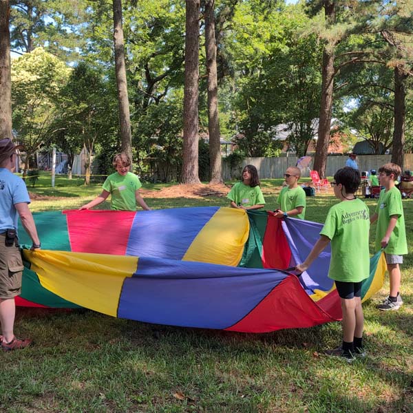 Scouts playing with a parachute at Bayside Day Camp
