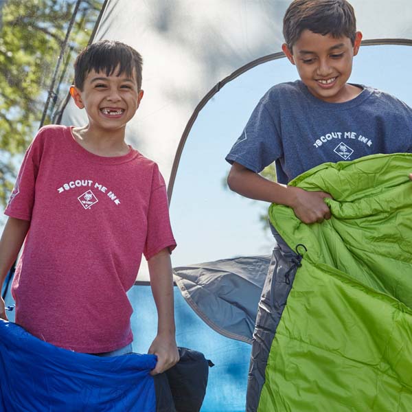 Two Cub Scouts in a tent with sleeping bags