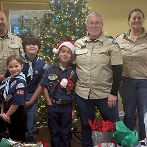 Cub Scouts and leaders from Pack 490 delivering gifts with SilverTree Seniors at Sullivan House