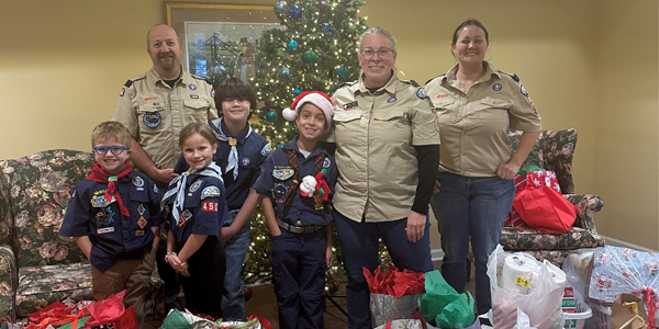 Cub Scouts and leaders from Pack 490 delivering gifts with SilverTree Seniors at Sullivan House