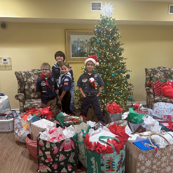 Cub Scouts from Pack 490 delivering gifts with SilverTree Seniors at Sullivan House