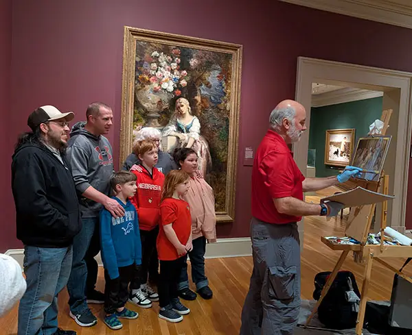 Scouts and family members from Pack 991 at the Chrysler Museum, watching Tom Callahan paint in the gallery