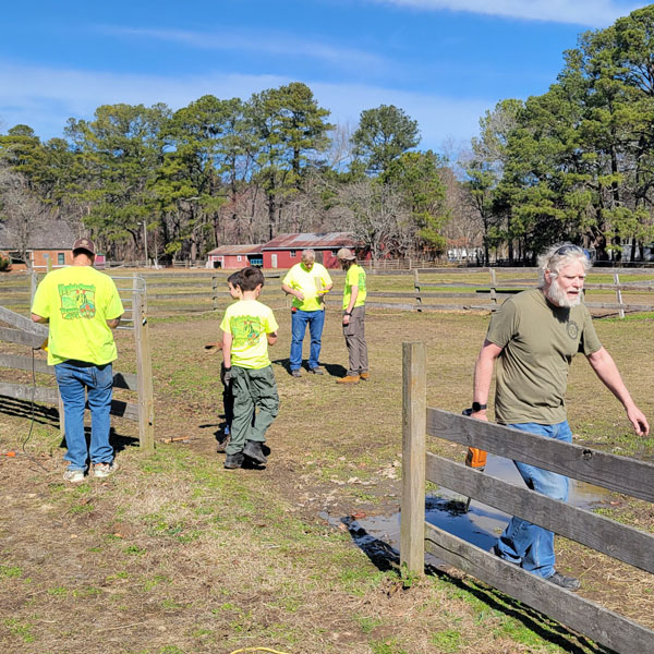 Scouts and leaders assisting with an Eagle Scout service project for for the nonprofit Rainbows and Reawakenings for Thoroughbreds,