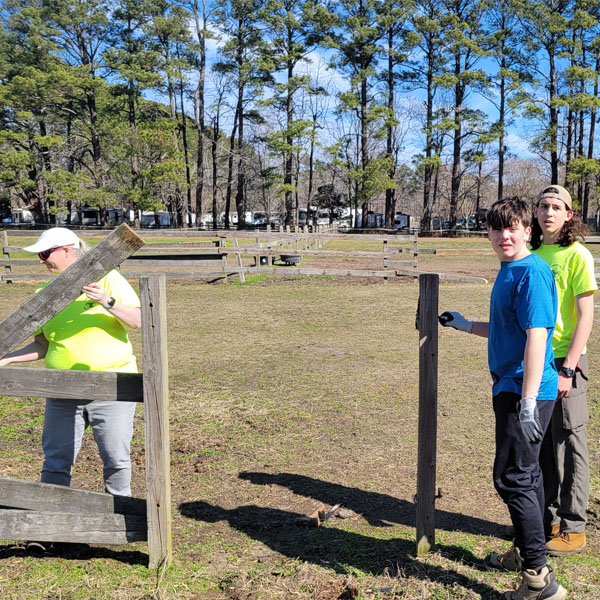 Scouts and leaders assisting with an Eagle Scout service project for for the nonprofit Rainbows and Reawakenings for Thoroughbreds,