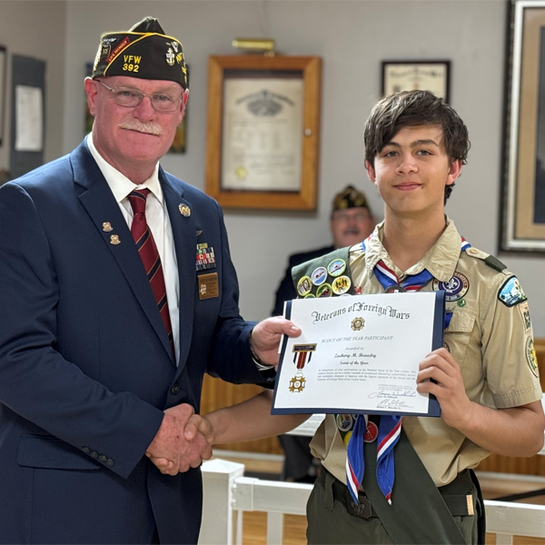 Eagle Scout Zachary B. of Troop 63 receiving the Scout of the Year Award from Veterans of Foreign Wars of the United States and the Auxiliary General MacArthur Memorial Post 392