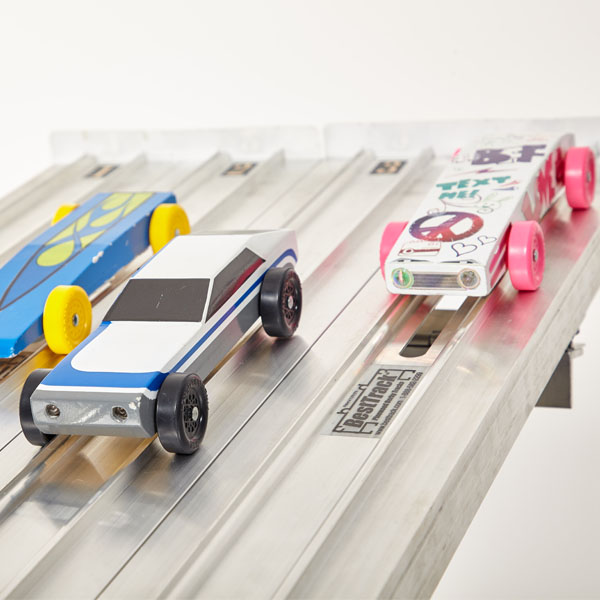 Pinewood Derby cars on track