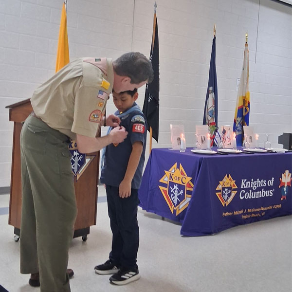Francis K. from Cub Scout Pack 408 with the Parvuli Dei Religious Emblem at the Four Chaplains Memorial Service on February 3, 2026