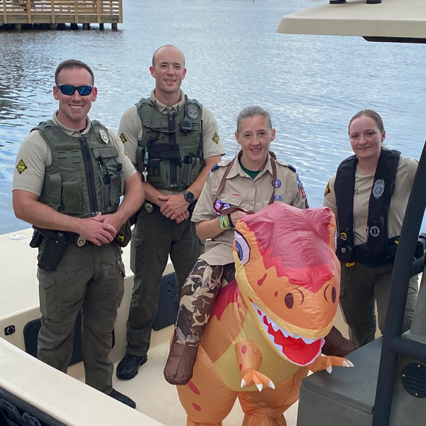 Scout leader with dinosaur costume at National Night Out, Elizabeth City, NC 2026